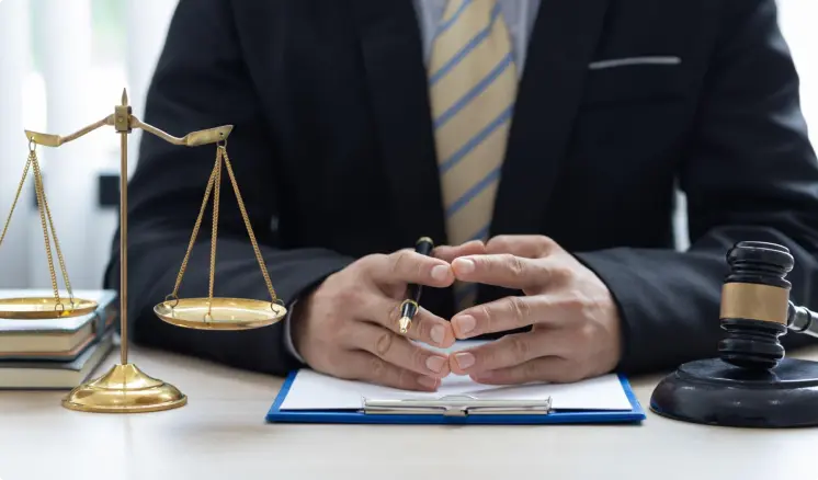 Ontario lawyer in his bureau next to a balance and a gable